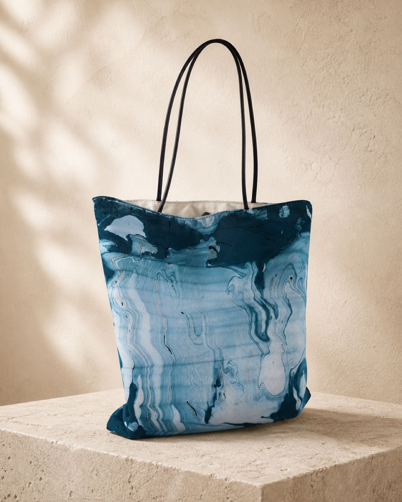 Polar Current pale blue and teal velvet shoulder bag on a warm stone plinth