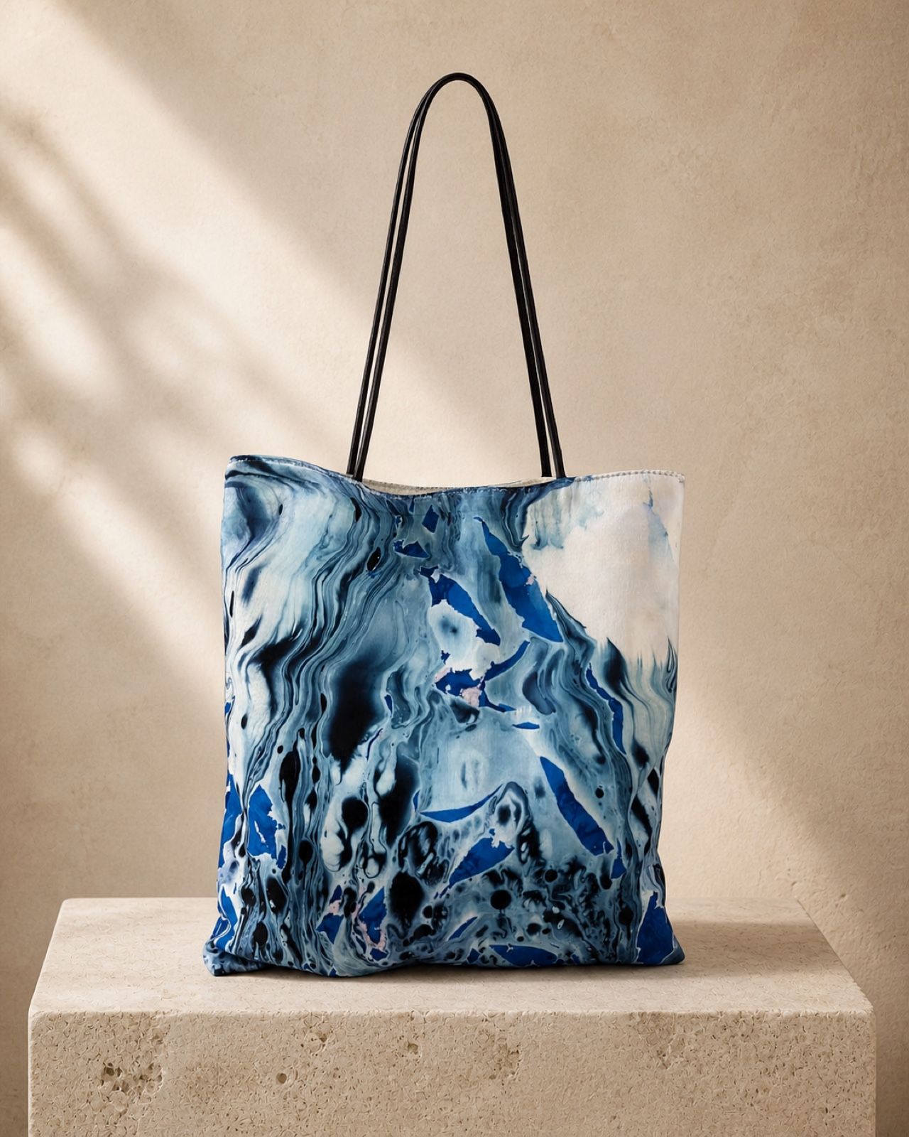 Midnight Estuary deep blue velvet shoulder bag on a cream travertine plinth