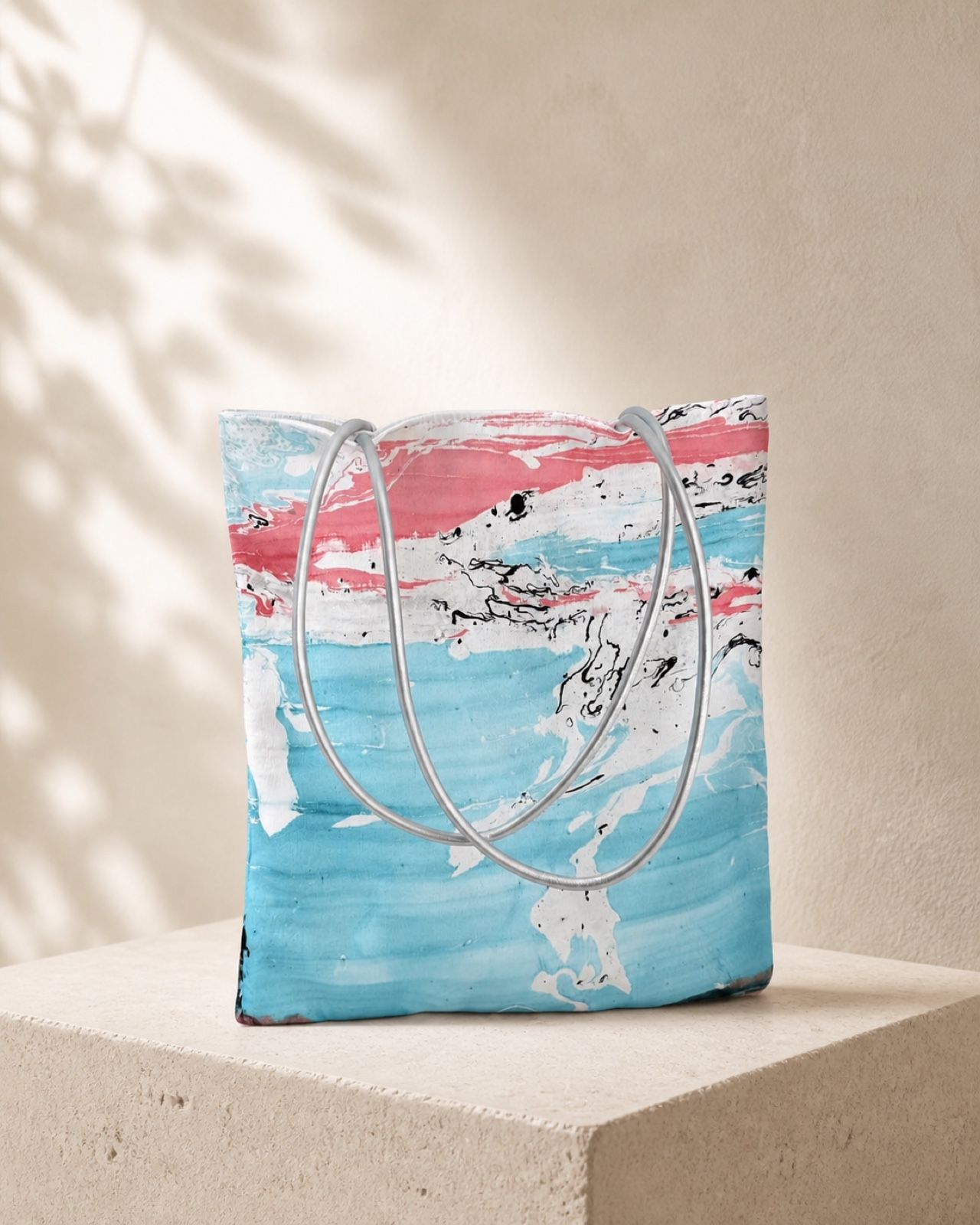 Summer Horizon blue and coral velvet shoulder bag on a cream stone plinth