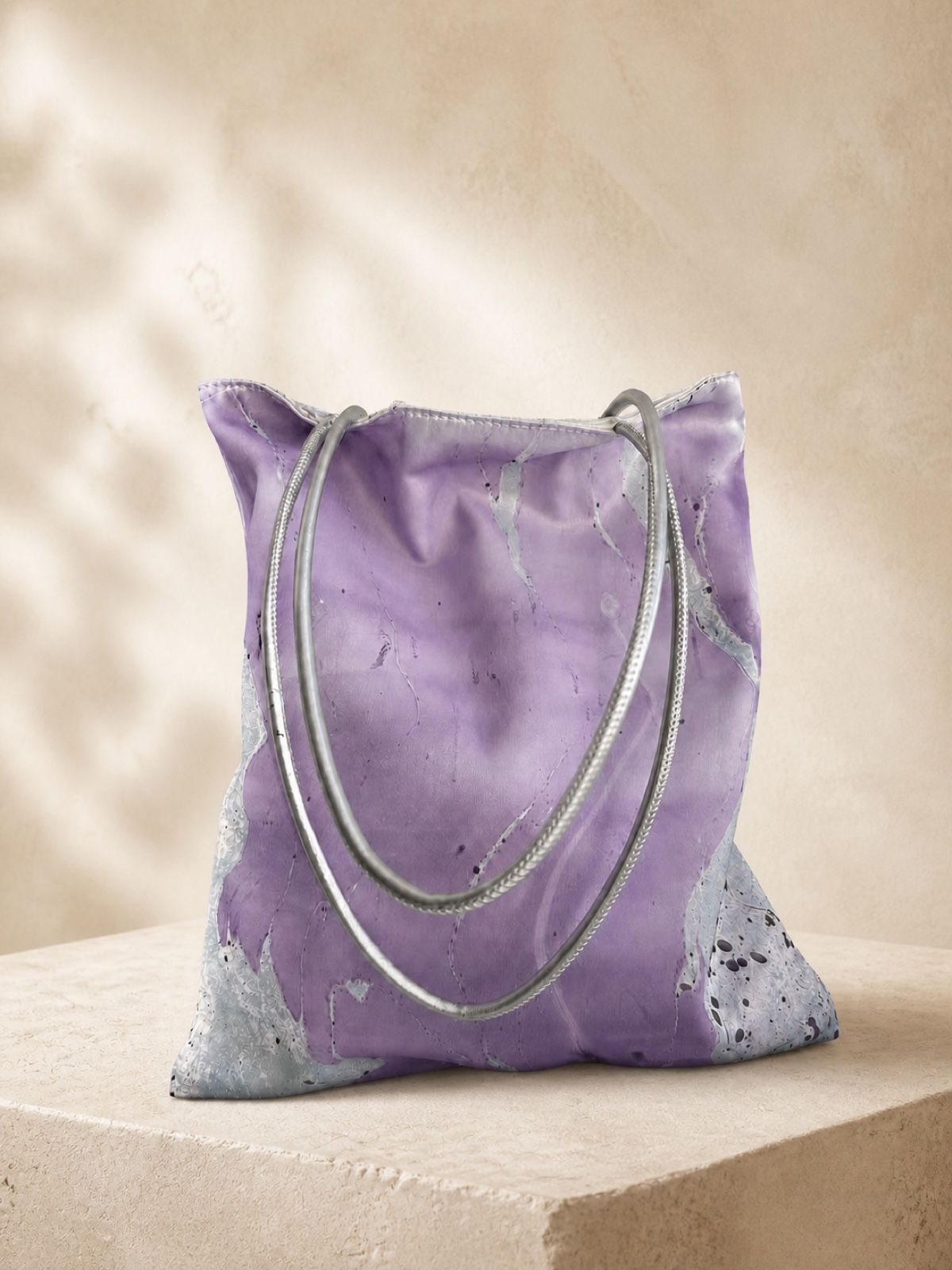 Violet Drift lavender velvet shoulder bag on a warm travertine plinth